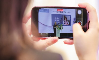 在2024上海國際文學周主論壇的會場，一位觀眾在用手機錄制日本推理小說家湊佳苗的發(fā)言。上海國際文學周供圖